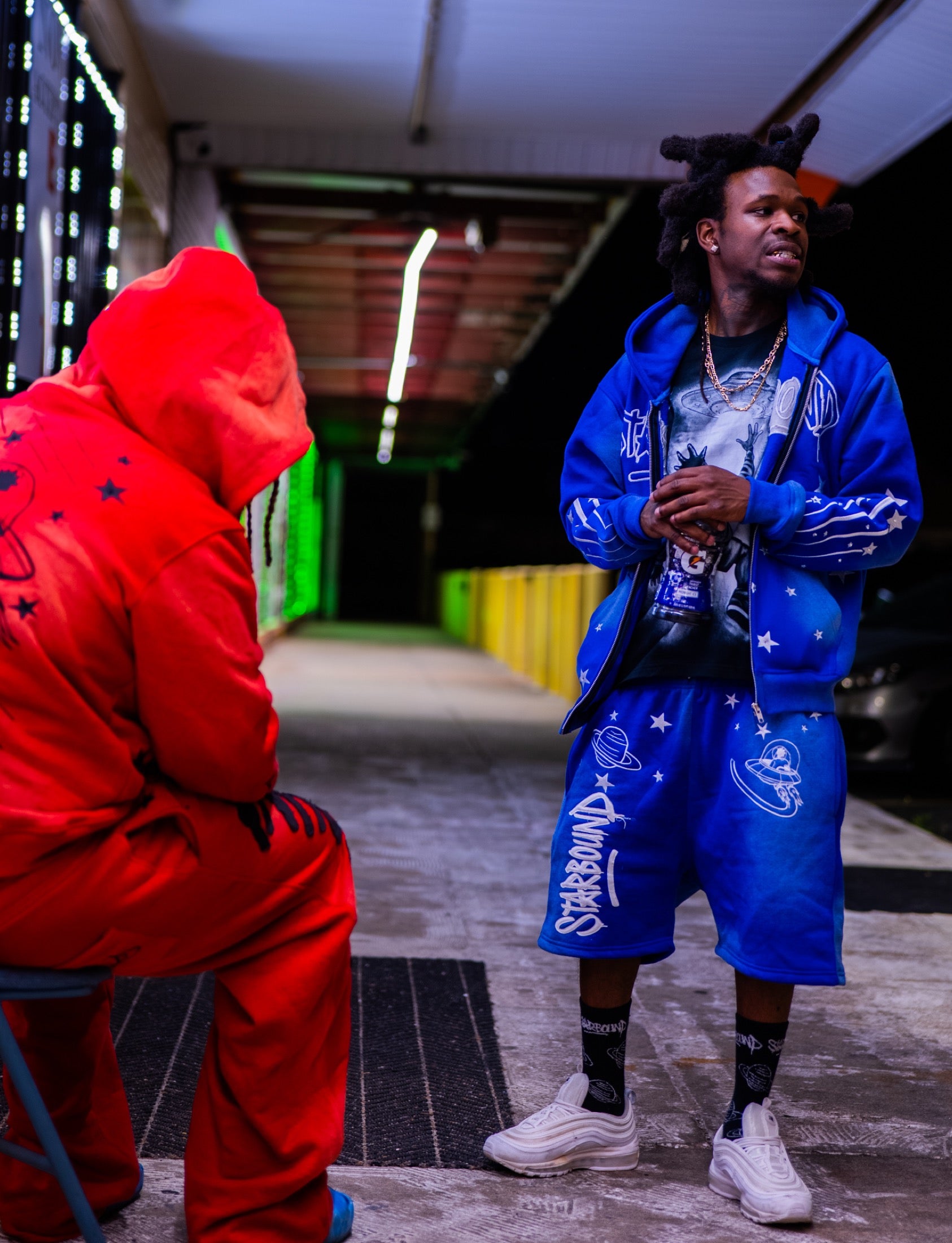 Models wearing red and Galaxy Blue Starbound sets